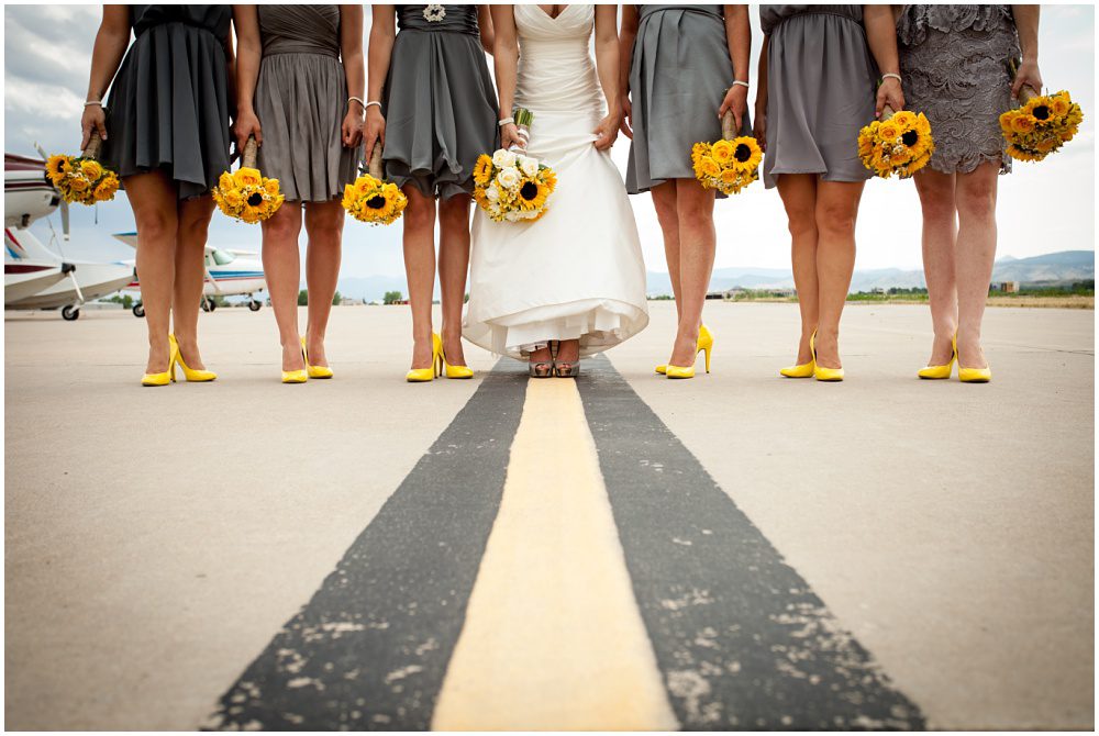 A bridal party with sunflower bouquets on a runway