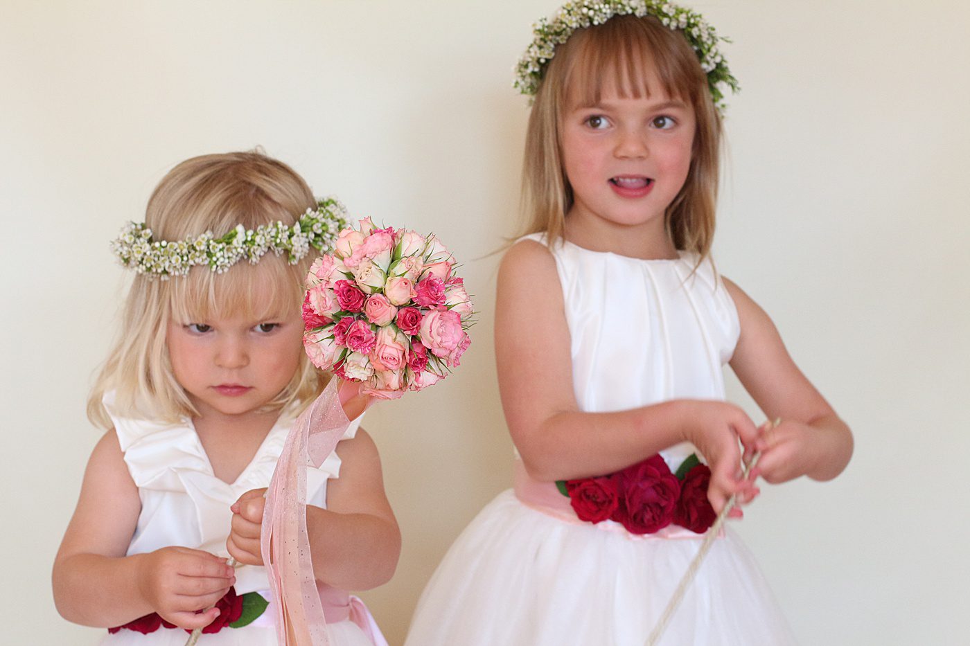 twop flower girls playing with flower wands