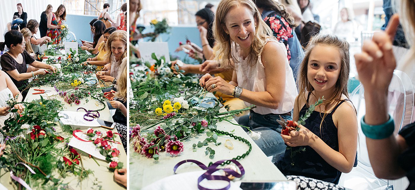a table full of women making flower crowns