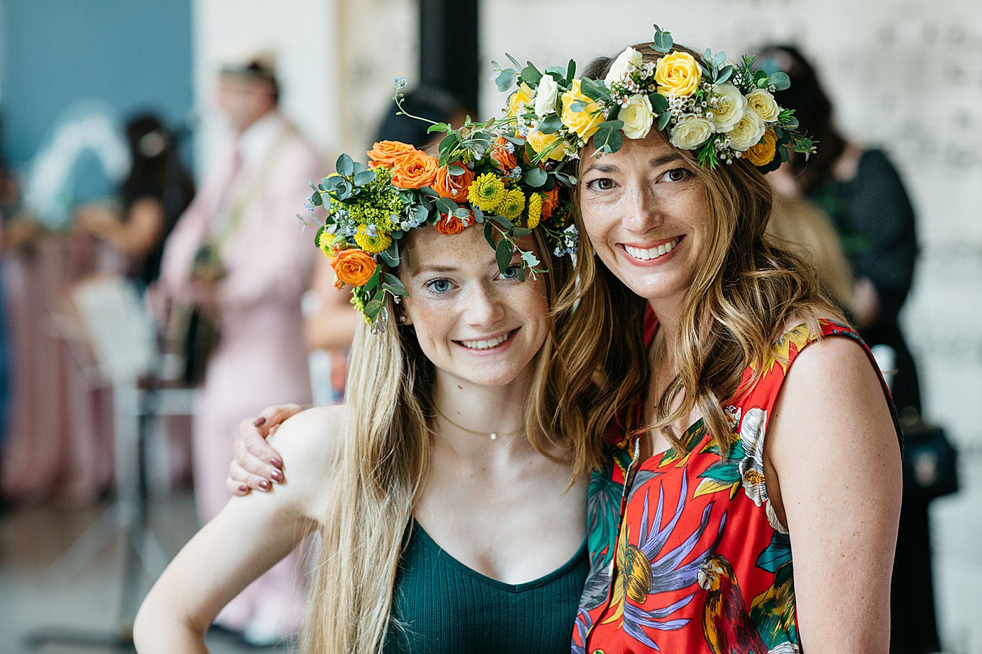 two ladies wearing flower crowns