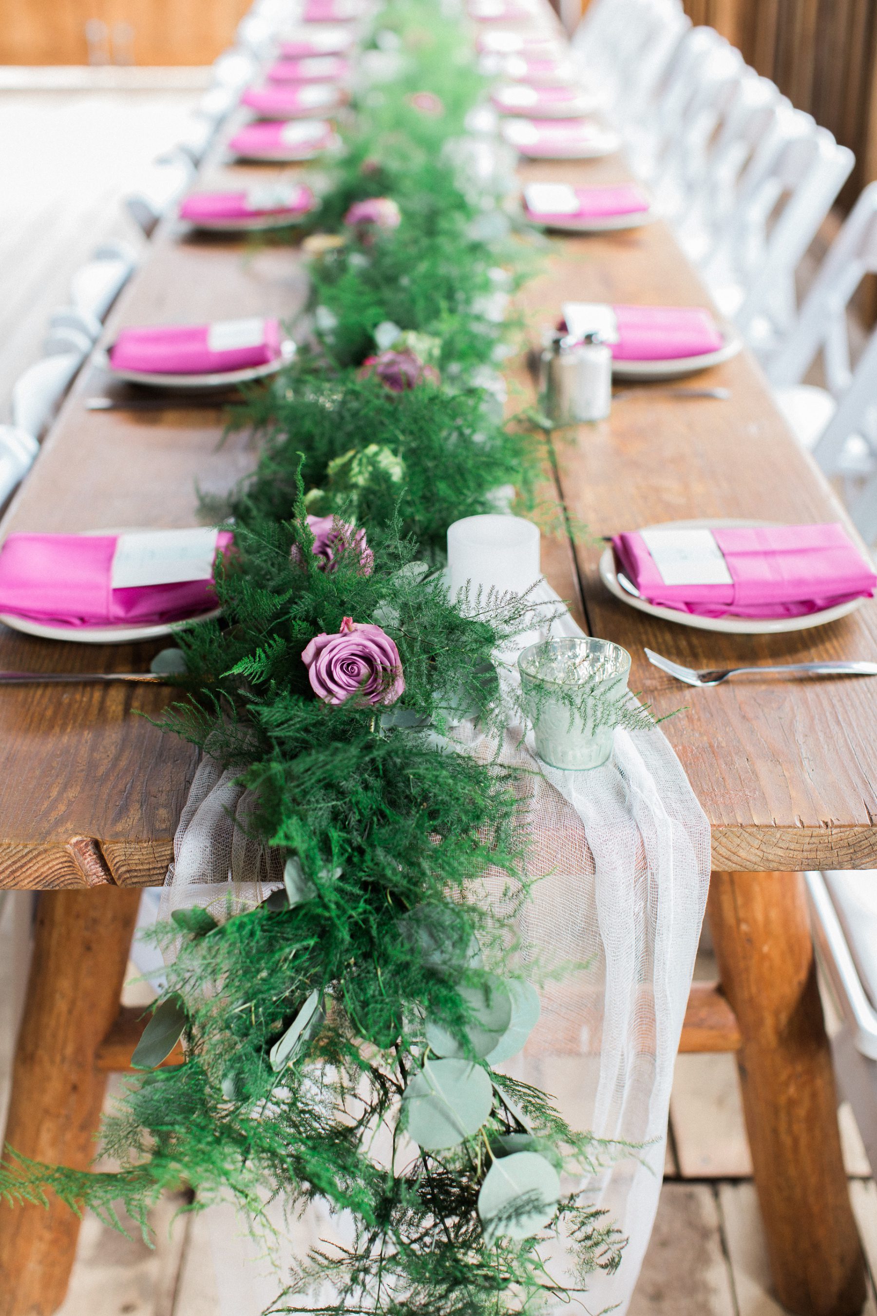 floral garland along table with lavender napkins