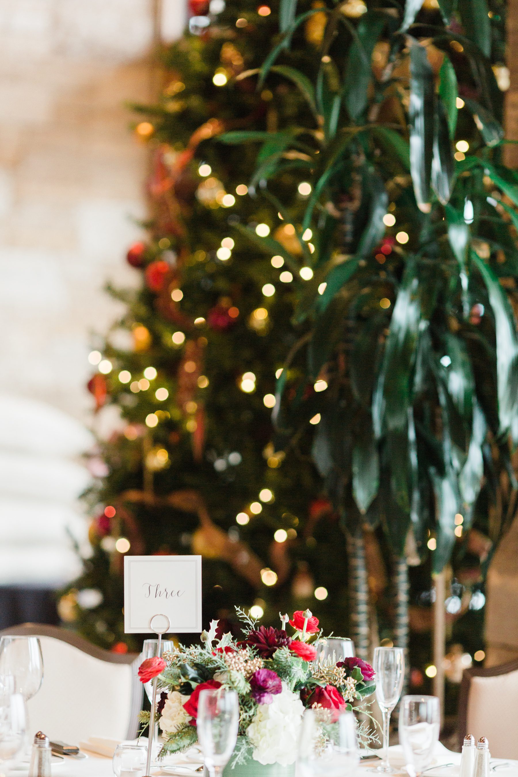 Floral centerpiece next to Christmas tree