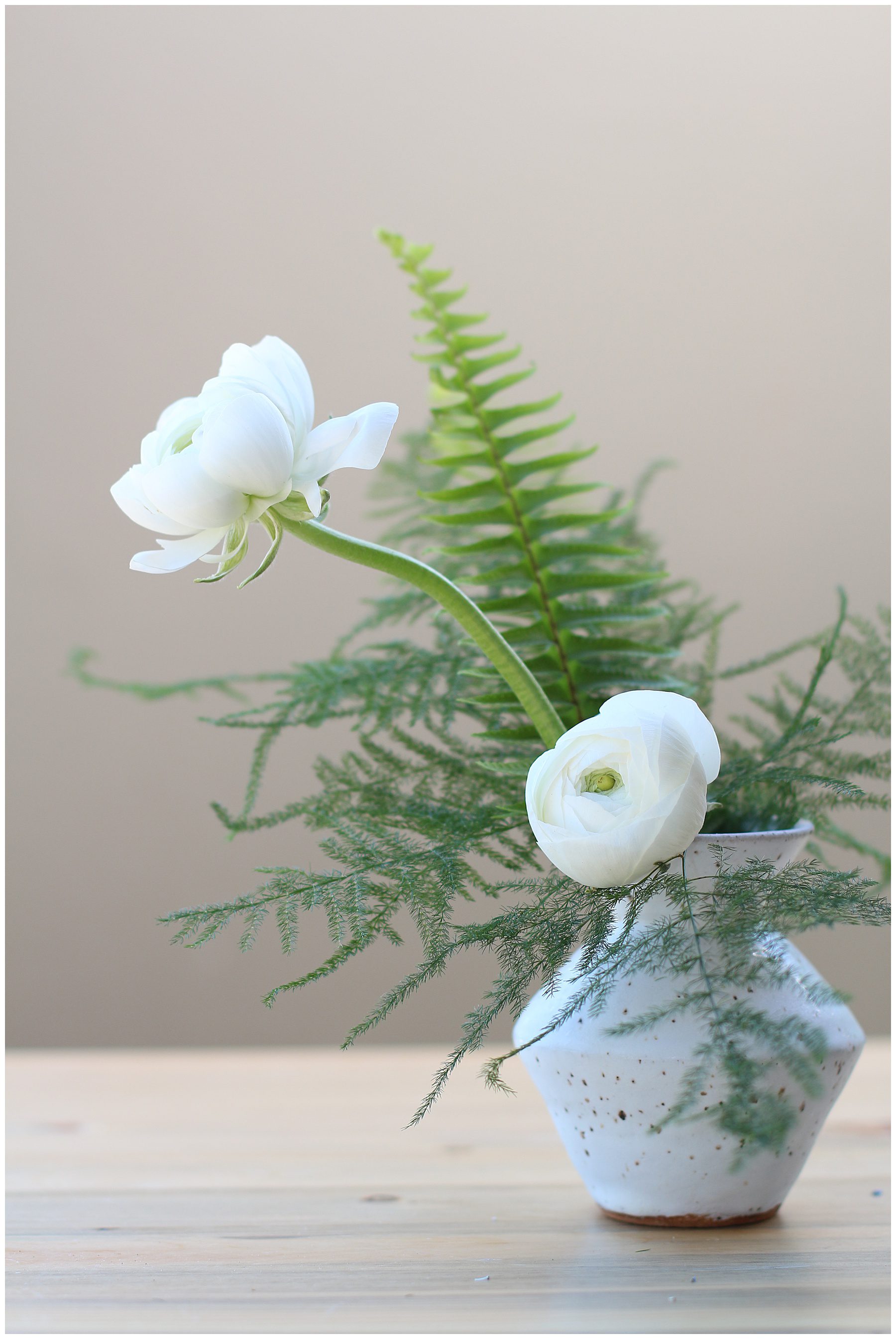 clay bud vase with white flowers