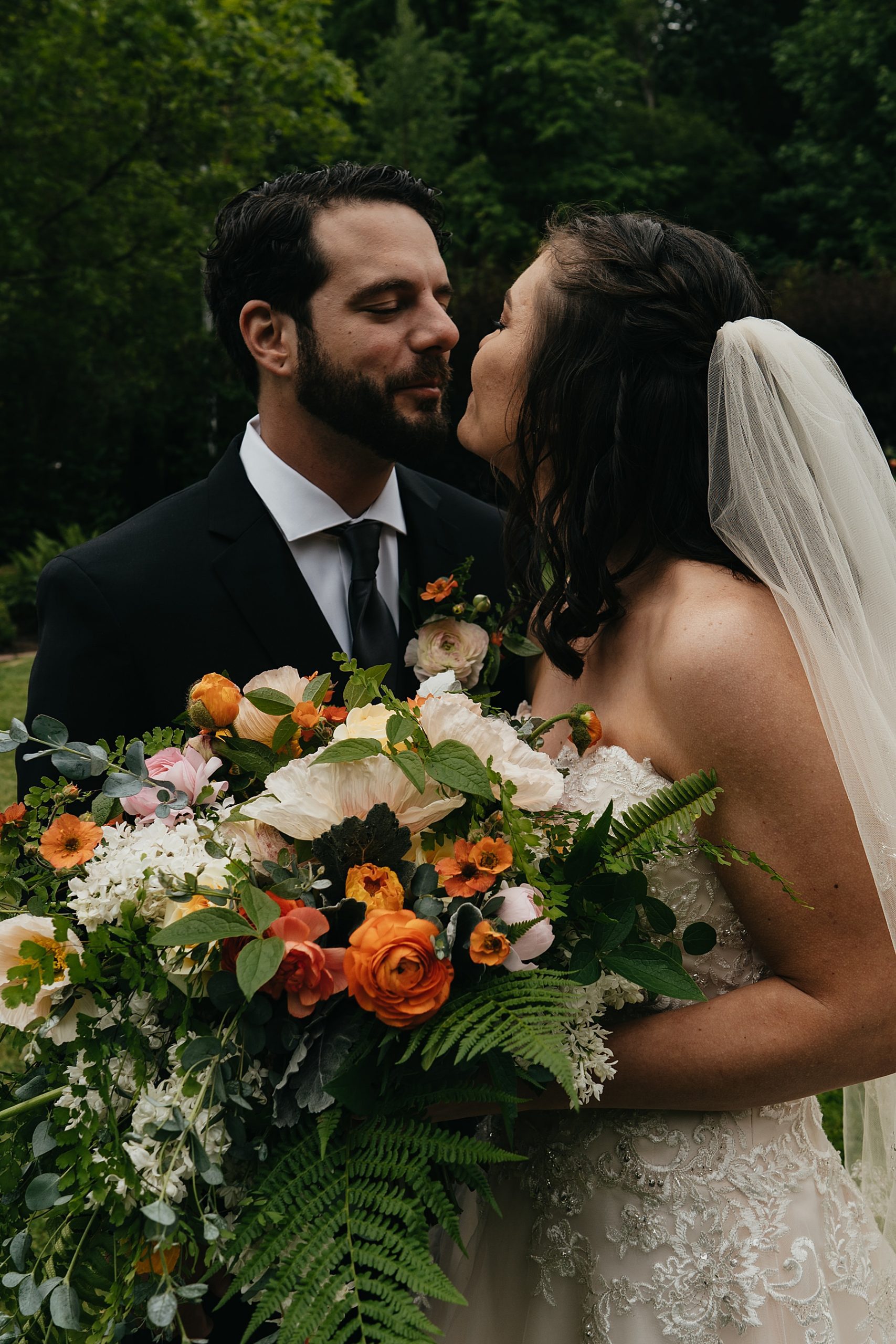 bride and groom with colorful bridal bouquet