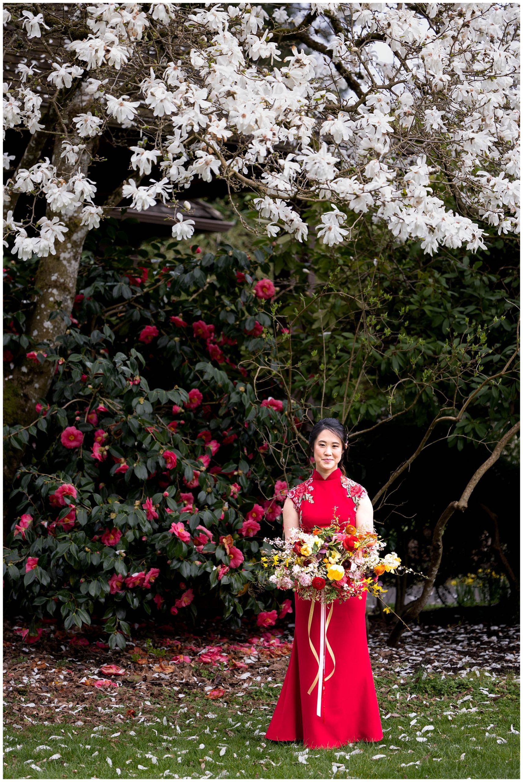 Chinese bride standing by flowering bush