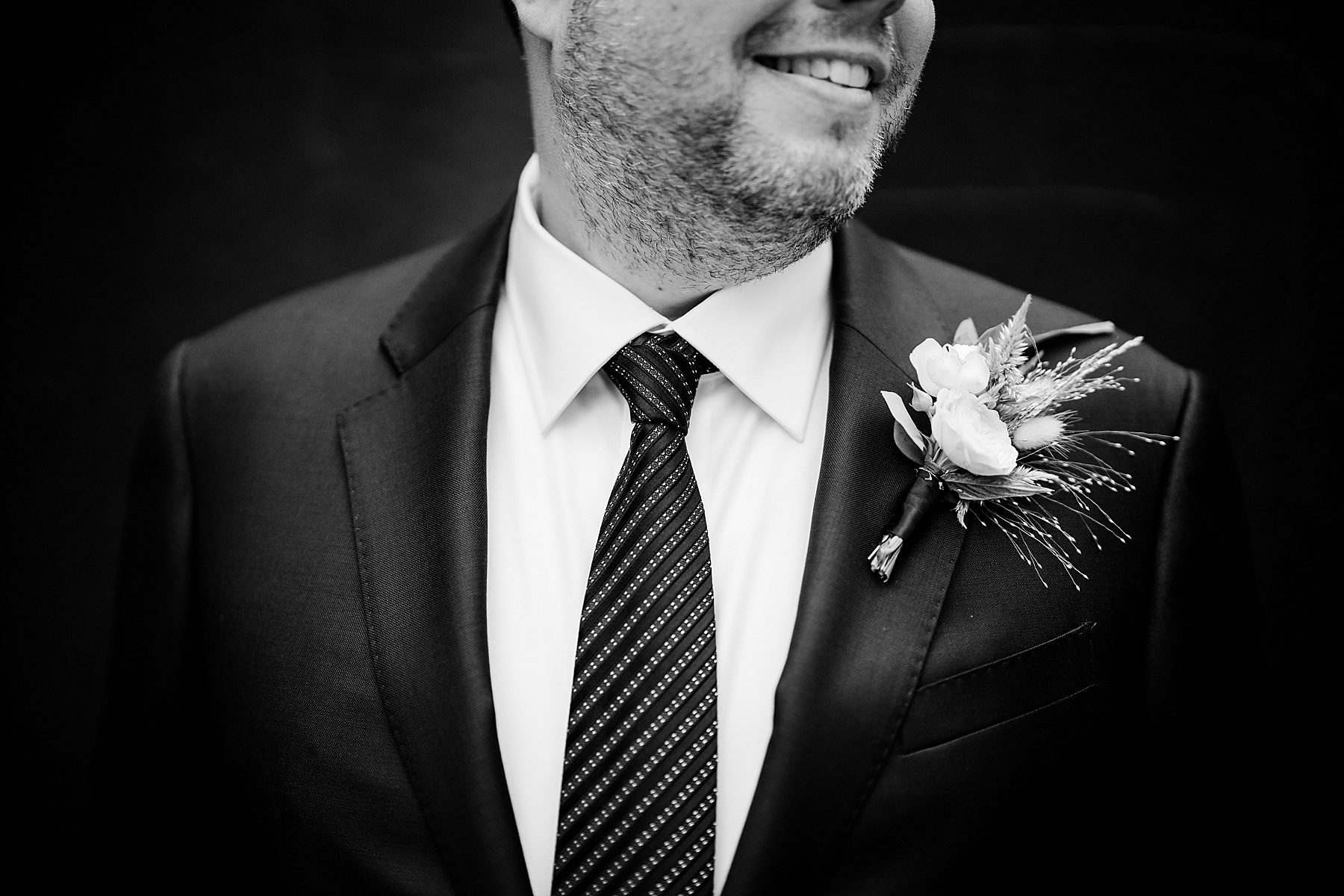 black and white image of a groom's boutonniere