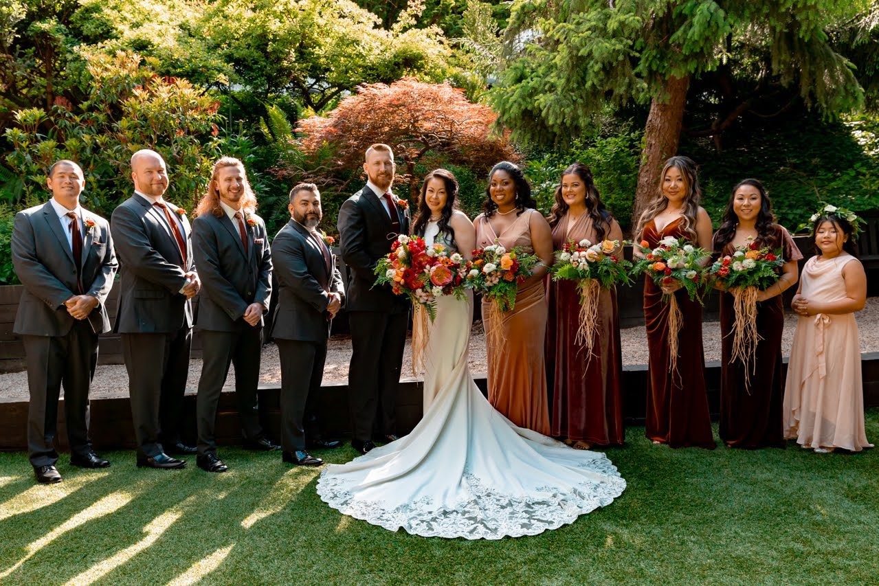 a wedding party holding colorful bouquets