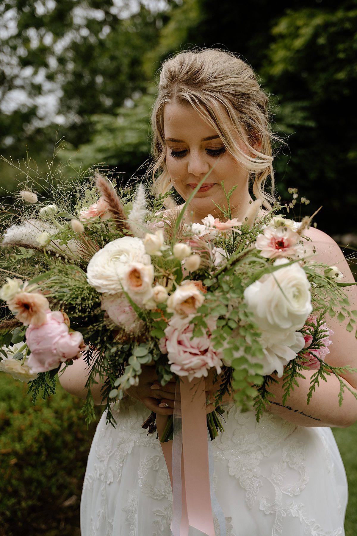 bride holding peony bouquet