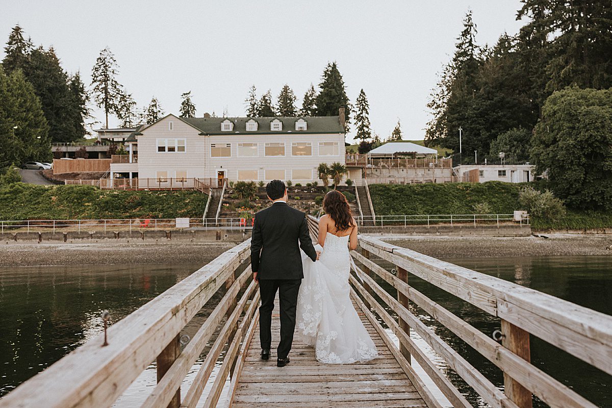 a bride and groom walk towards the Olympia Country Club