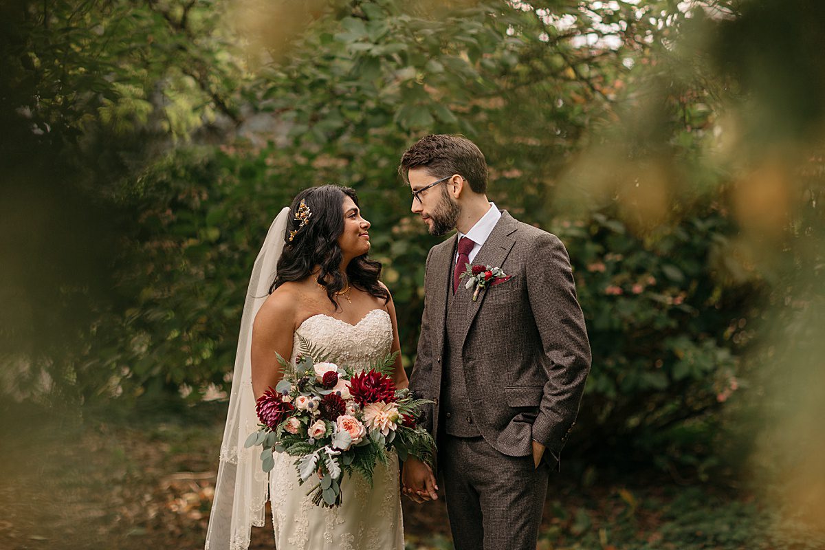 bride and groom holding fall bridal bouquet