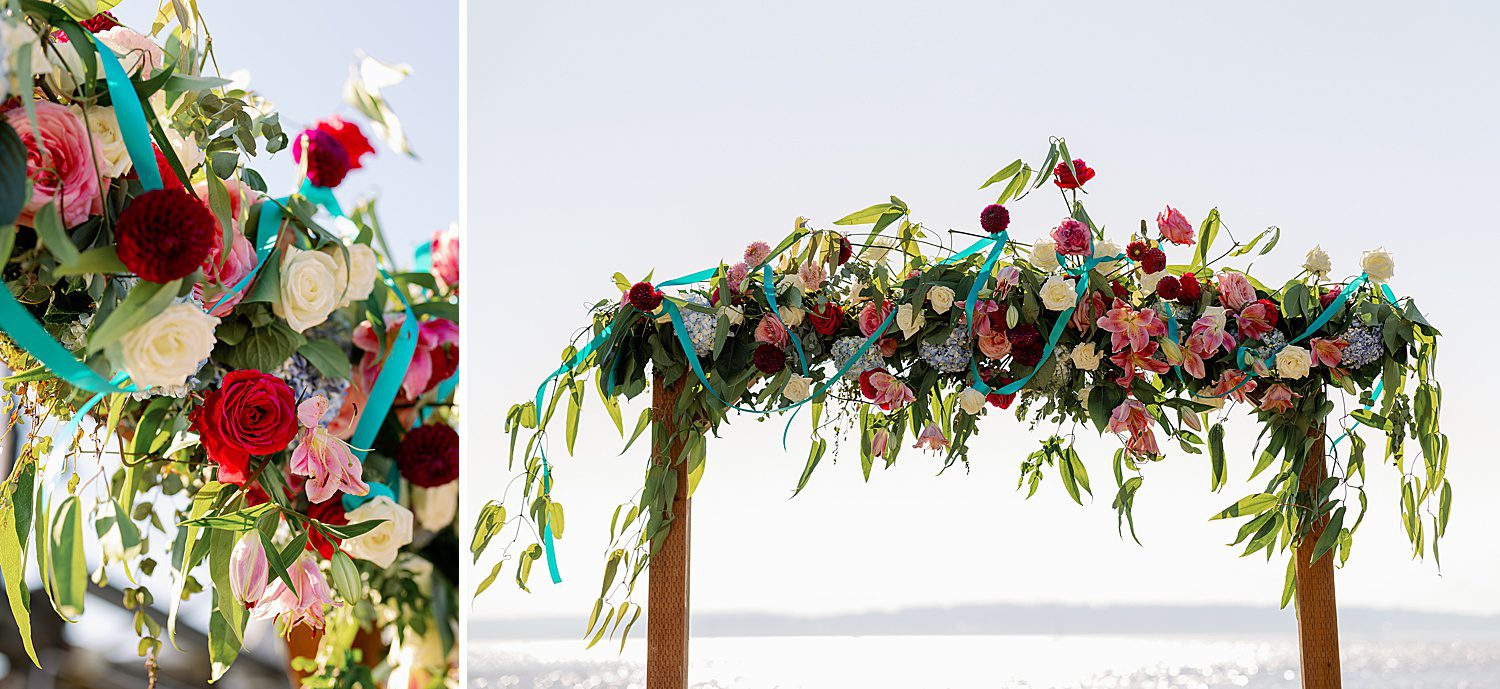 wedding arch with pink and red flowers and turquoise ribbon