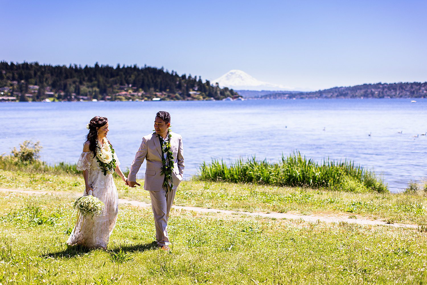 bride and groom walking at Seward Park Seattle