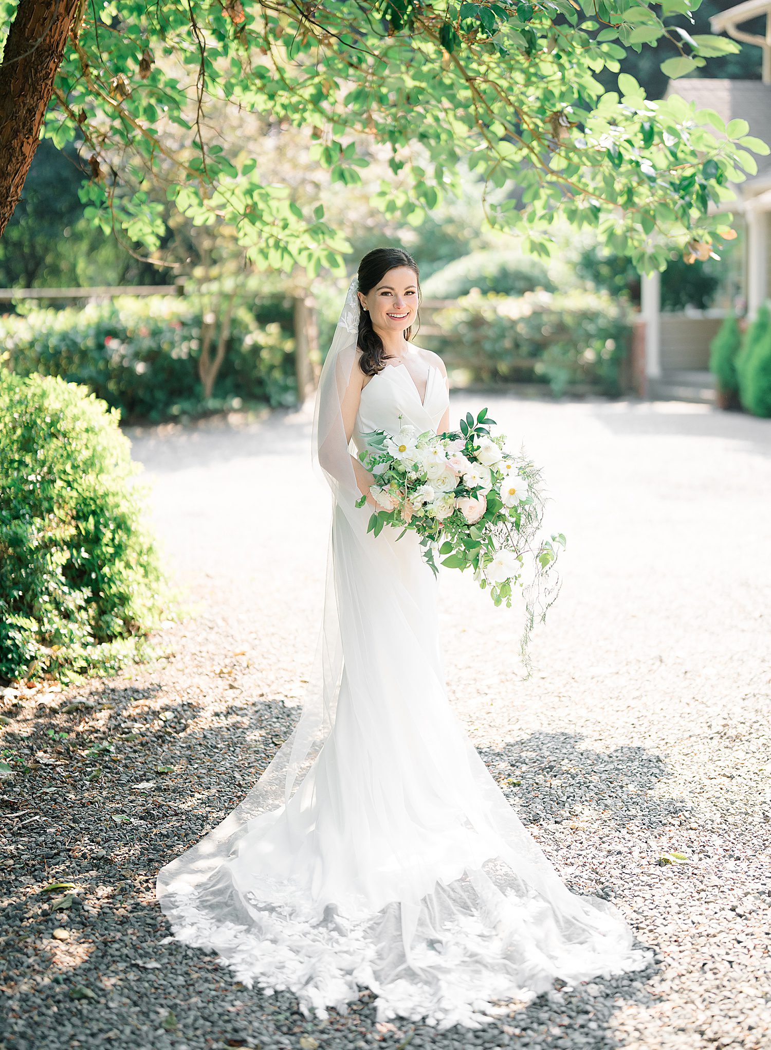 bride holding white and blush wedding bouquet