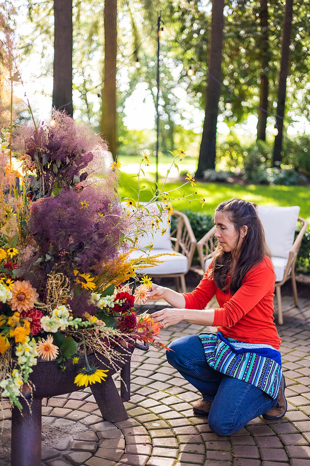 woman making a fire out of fresh flowers